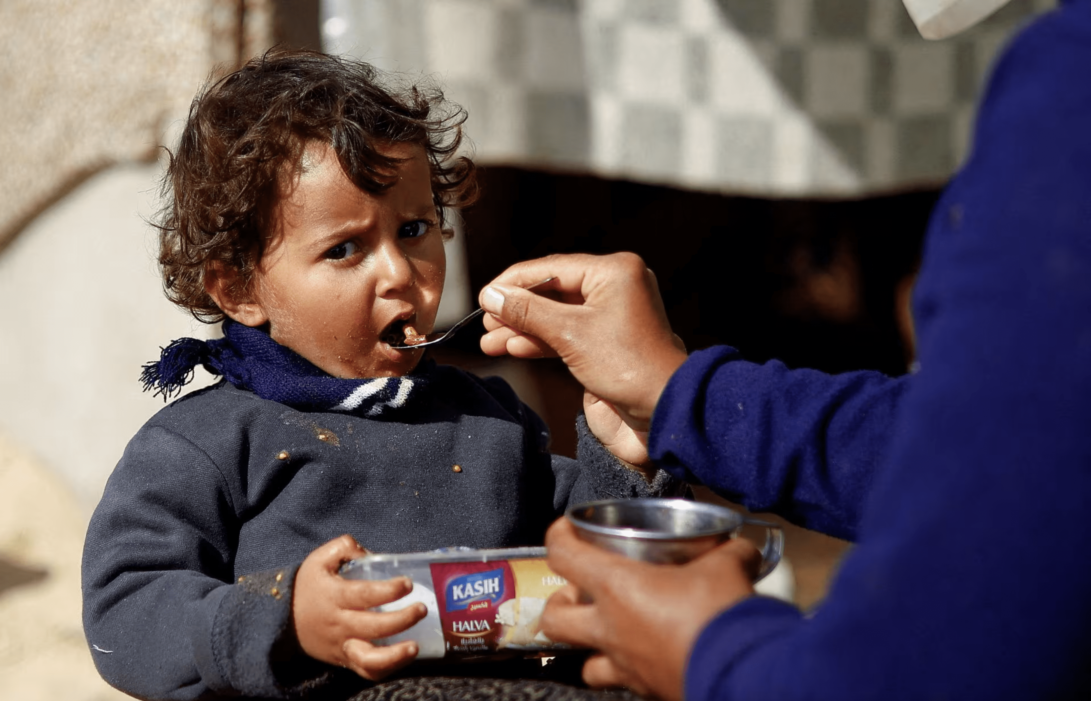 A displaced Palestinian child, who fled due to Israeli strikes, eats, amid the ongoing conflict between Israel and Hamas, in Rafah in the southern Gaza Strip, February 20, 2024. REUTERS